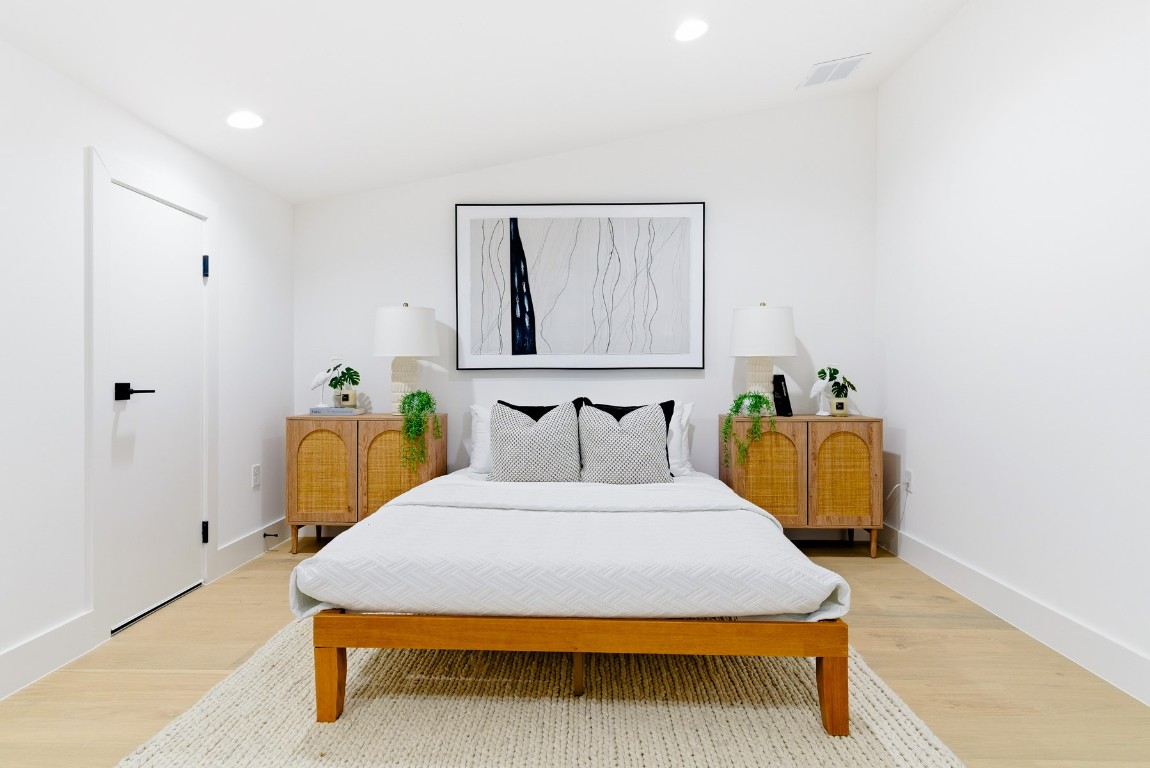 4613 Bolm Road Austin, TX 78702 - Photo 32 of 40 Bedroom featuring recessed lighting, wood finished floors, and lofted ceiling