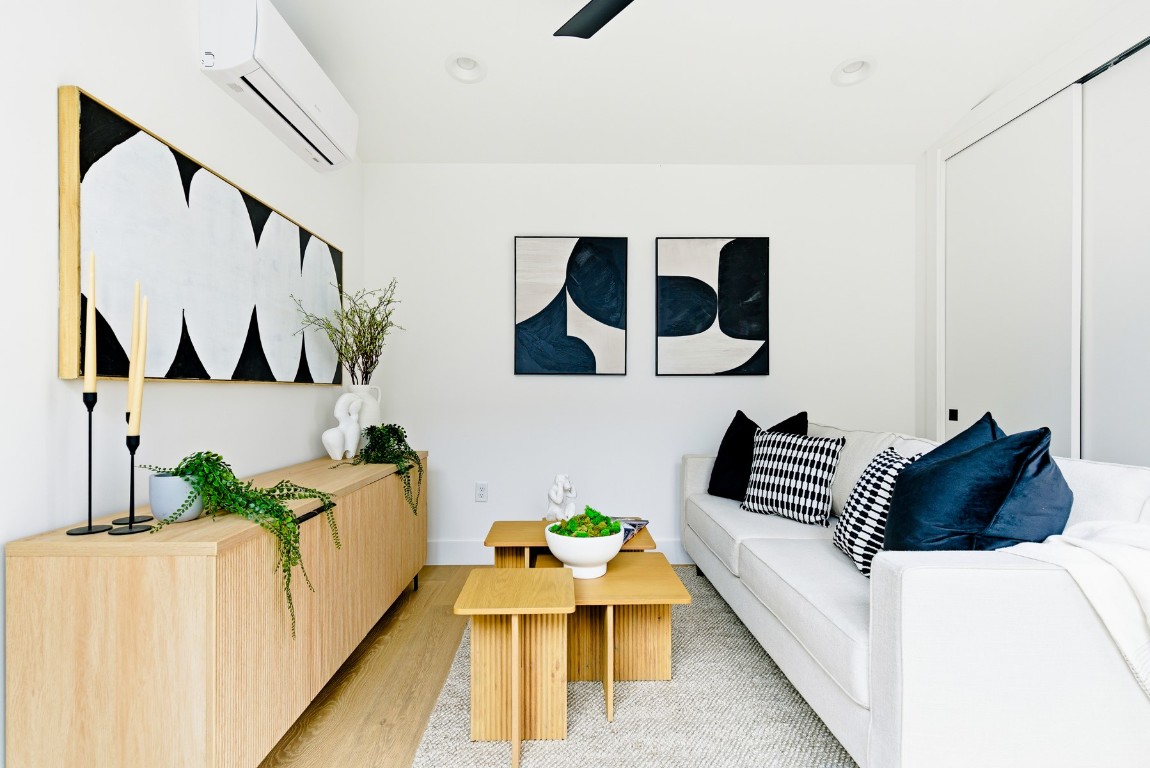 4613 Bolm Road Austin, TX 78702 - Photo 36 of 40 Living room with wood finished floors and a wall mounted air conditioner