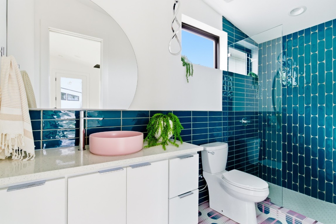 4613 Bolm Road Austin, TX 78702 - Photo 37 of 40 Full bath with a walk in shower, vanity, tile walls, and tile patterned floors