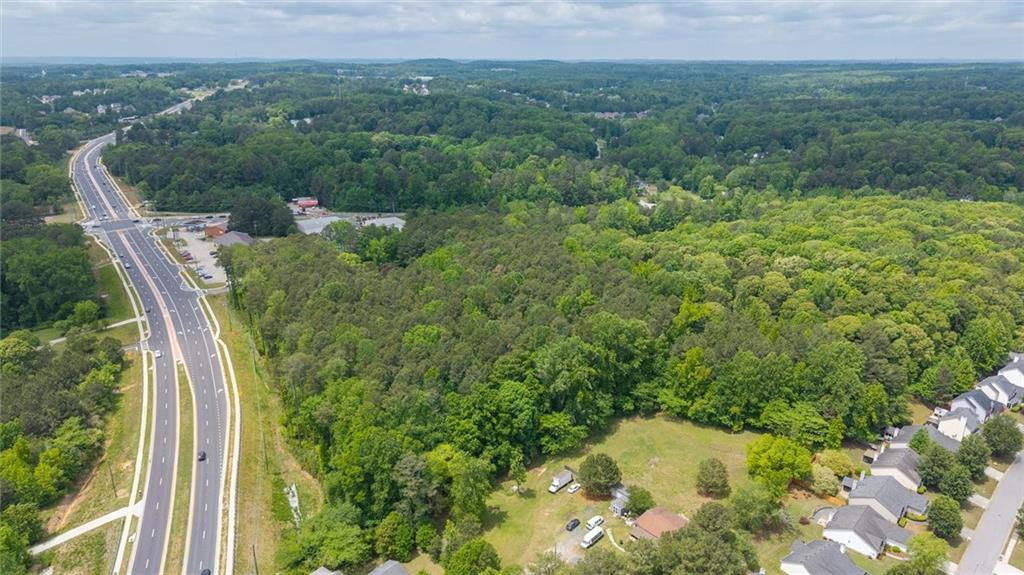 0 Macland Road Dallas, GA 30157 - Photo 5 of 12 a view of a lush green forest with trees and some houses