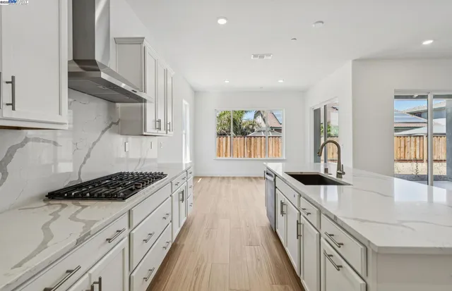 a kitchen with granite countertop a stove and a sink