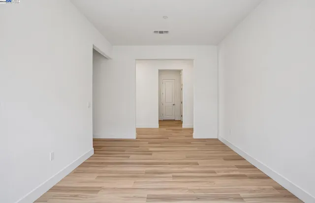 a view of a room with wooden floor