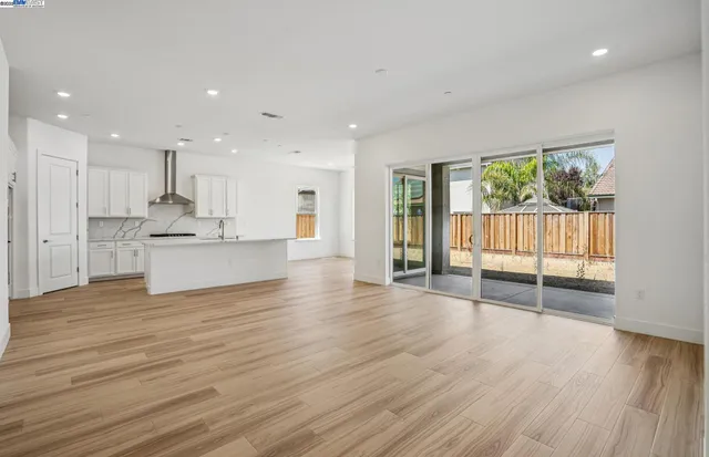 a view of kitchen with wooden floor and electronic appliances