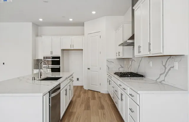 a kitchen with kitchen island a sink a stove and refrigerator
