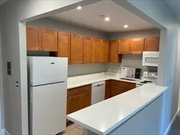 a kitchen with a refrigerator a sink and cabinets