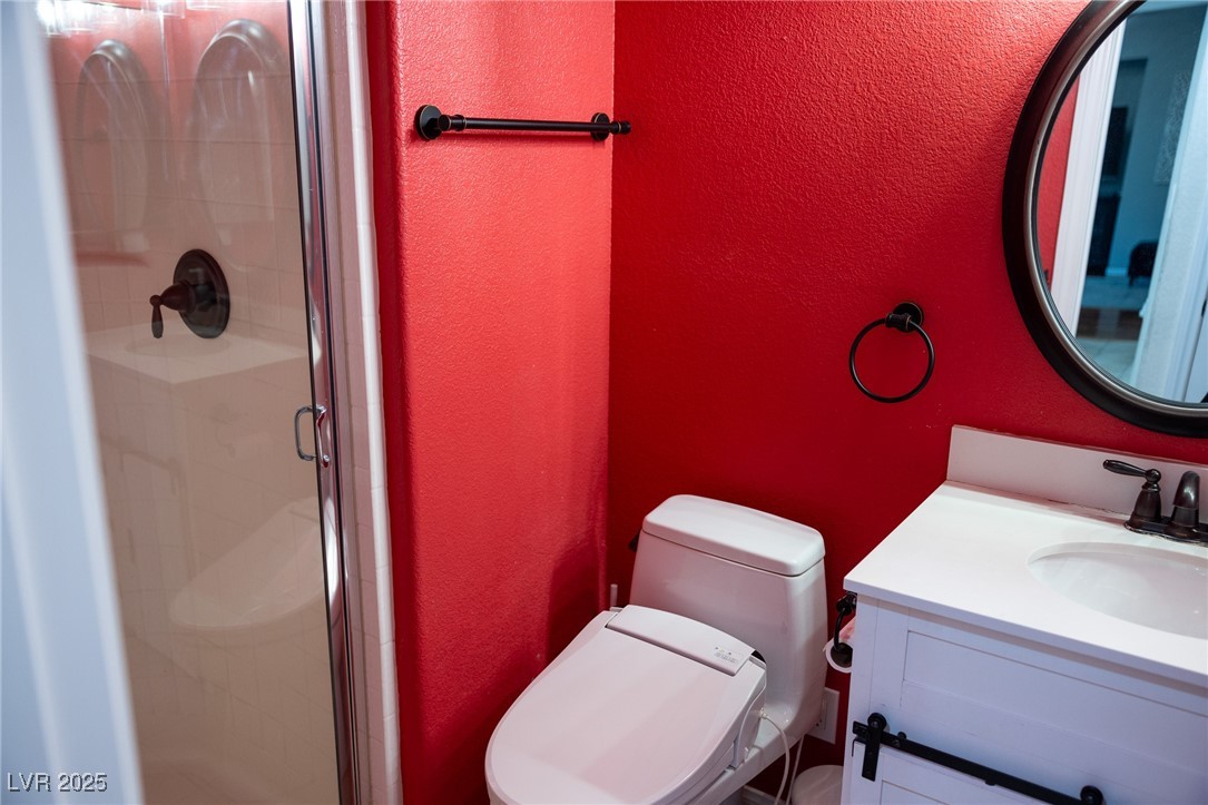 212 Malcolm Street Henderson, NV 89074 - Photo 19 of 47 Bathroom featuring a textured wall, vanity, and a shower stall