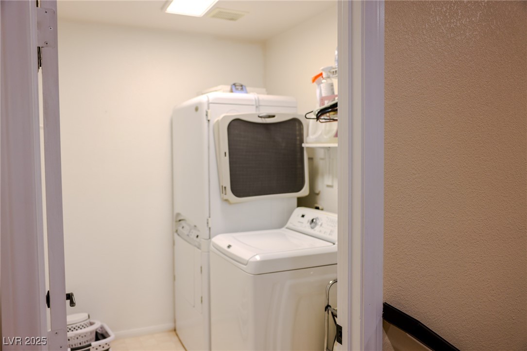 212 Malcolm Street Henderson, NV 89074 - Photo 22 of 47 Laundry room featuring washing machine and dryer and baseboards