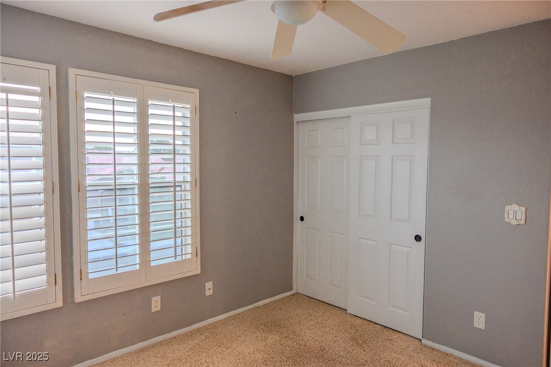 212 Malcolm Street Henderson, NV 89074 - Photo 24 of 47 UPSTAIRS. Unfurnished bedroom with light carpet, a closet, and a ceiling fan