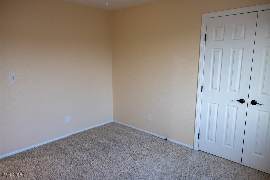 212 Malcolm Street Henderson, NV 89074 - Photo 28 of 47 Carpeted empty room featuring baseboards
