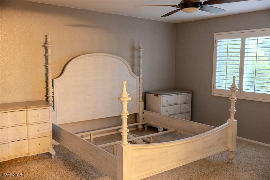 212 Malcolm Street Henderson, NV 89074 - Photo 30 of 47 Primary Bedroom - Upstairs with Wood shutters. Carpeted bedroom with a ceiling fan and baseboards