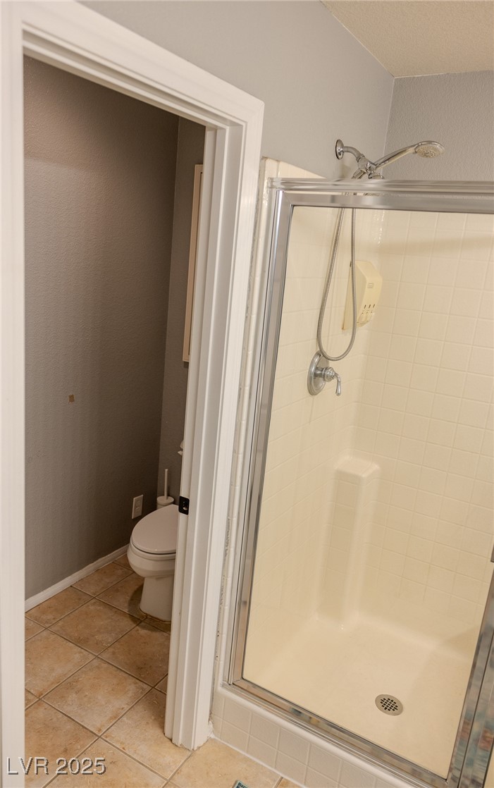 212 Malcolm Street Henderson, NV 89074 - Photo 34 of 47 Full bath featuring a stall shower and light tile patterned floors