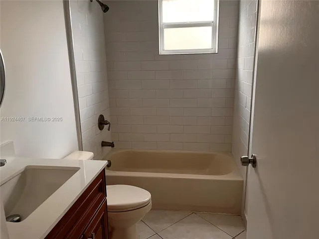 a white bath tub sitting next to a white toilet and sink