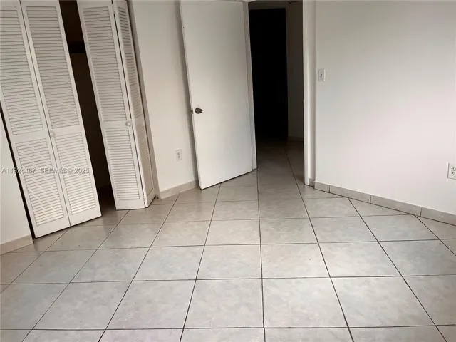 a view of a livingroom with an empty space and a window