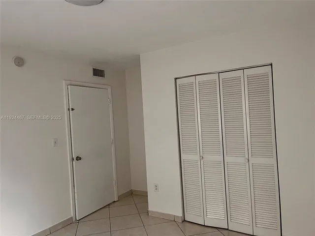 a view of a bathroom with a wooden door