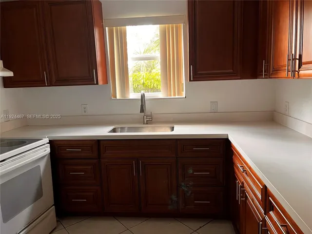 a sink with wooden cabinets and a sink