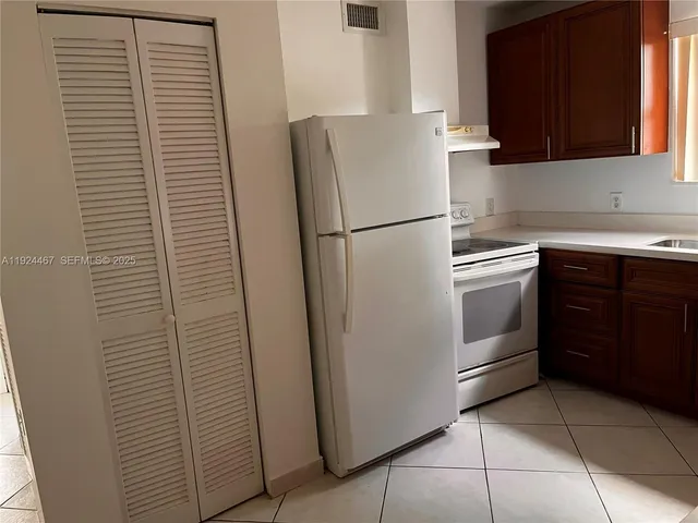 a white refrigerator freezer sitting in a kitchen