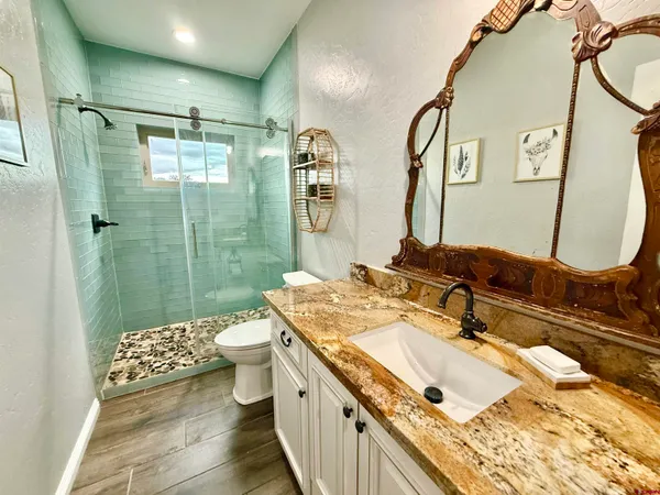 a bathroom with a double vanity sink a mirror and a bathtub