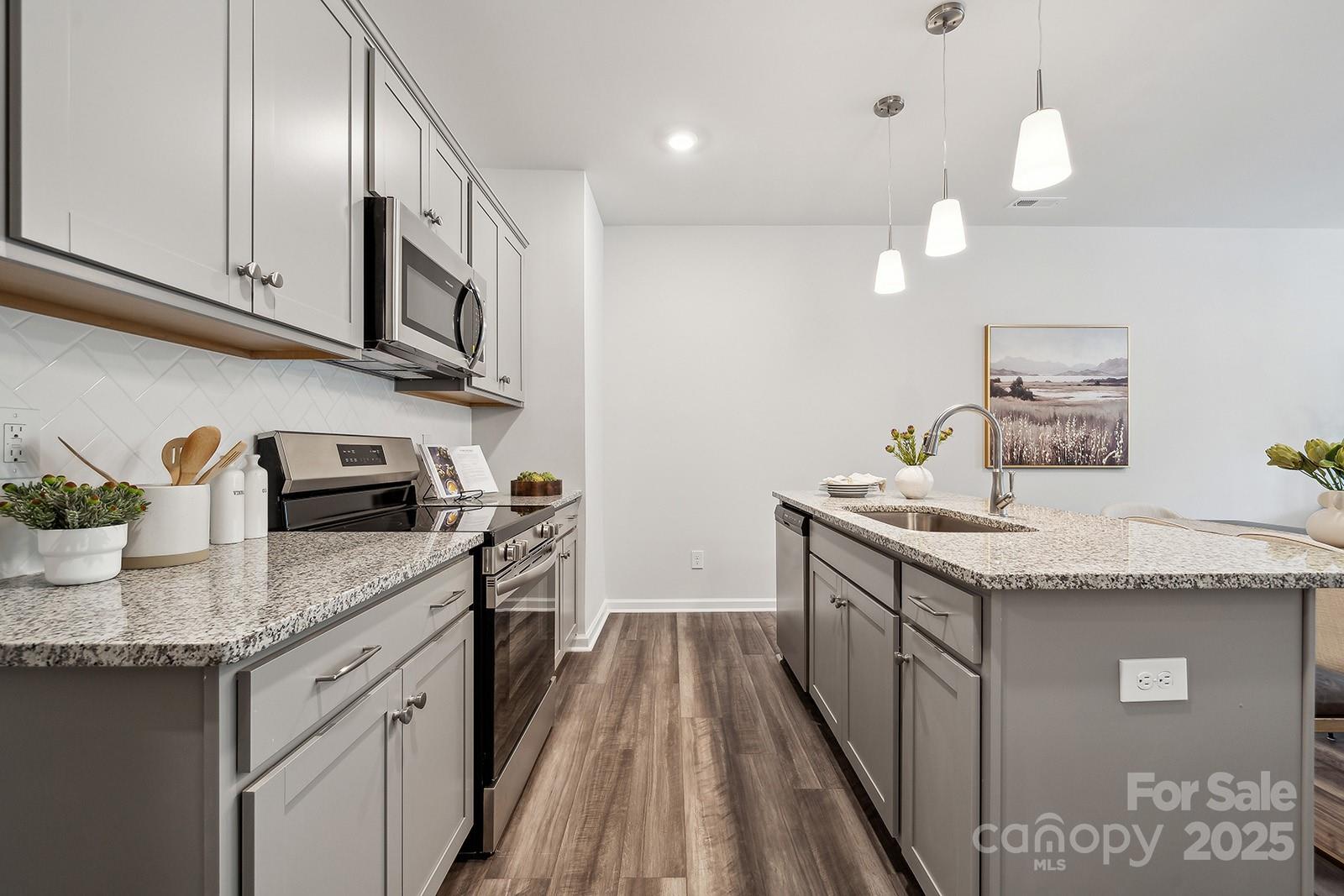 4754 Lakeview Road, Unit 19 Charlotte, NC 28216 - Photo 14 of 27 a kitchen with stainless steel appliances granite countertop a sink stove and cabinets
