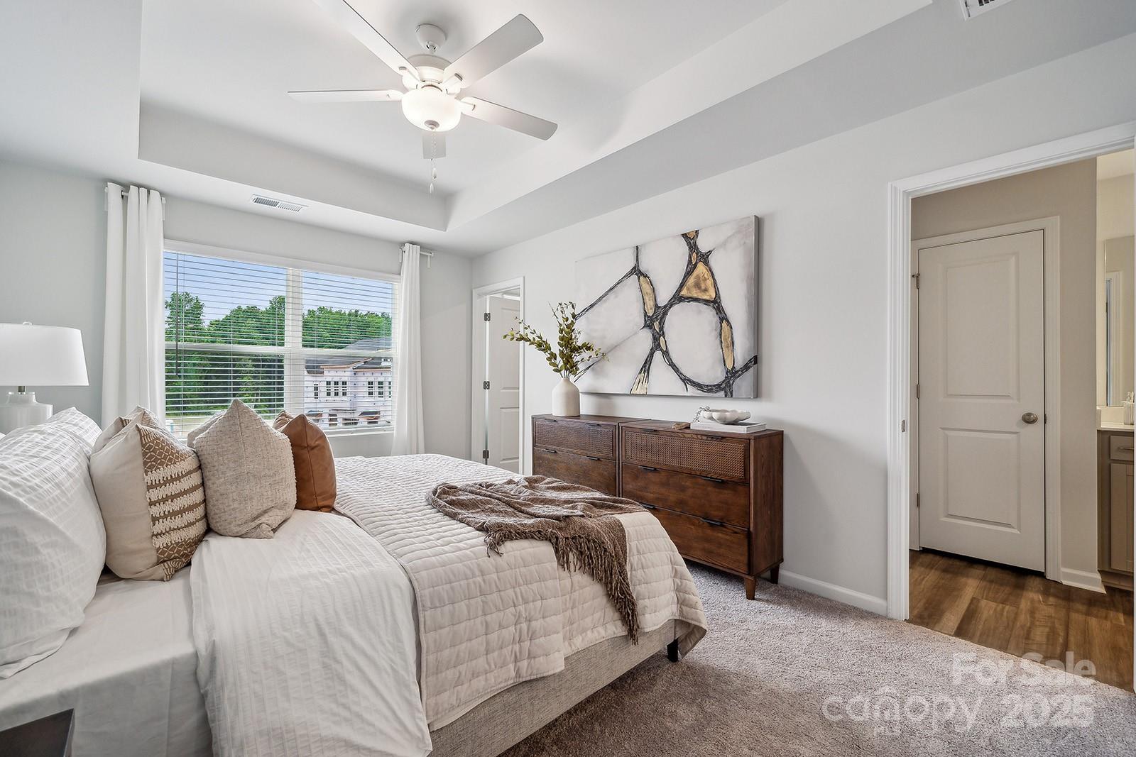 4754 Lakeview Road, Unit 19 Charlotte, NC 28216 - Photo 19 of 27 a bedroom with a bed and a chandelier