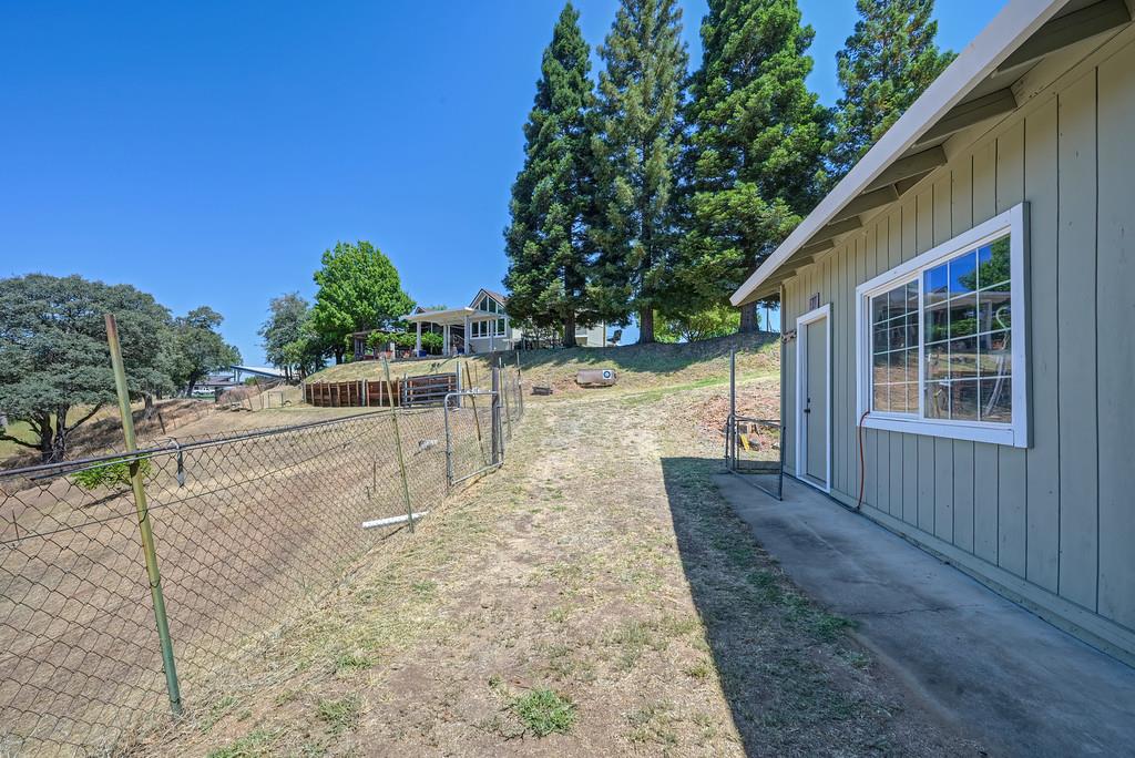 7630 Ridge Road Newcastle, CA 95658 - Photo 75 of 85 View of side of workshop and home at distance.