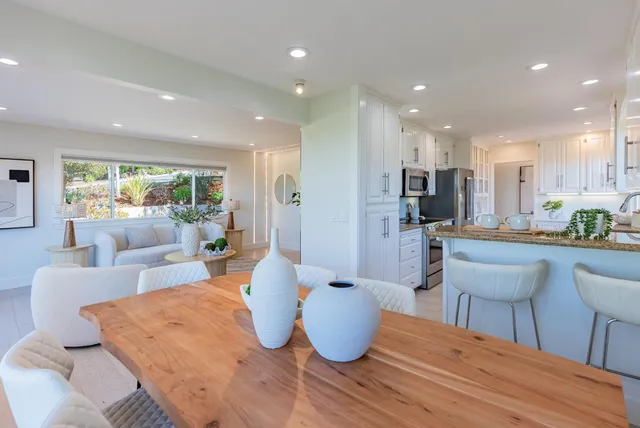 a kitchen with stainless steel appliances granite countertop a sink refrigerator and cabinets