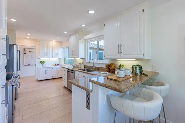 a kitchen with stainless steel appliances a refrigerator stove and sink