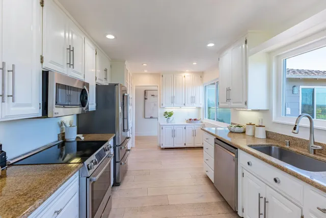 a kitchen with lots of counter space and wooden floor