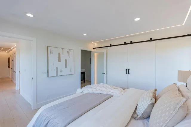 a bedroom with a bed and a large window