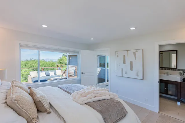 a bedroom with furniture and a large window