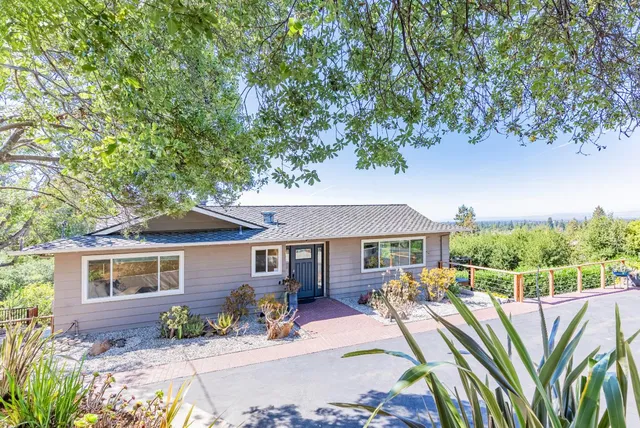a house view with a sitting space and garden