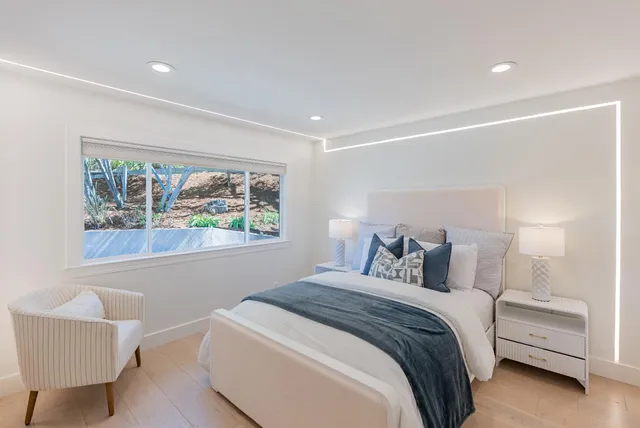 a living room with a bed and furniture