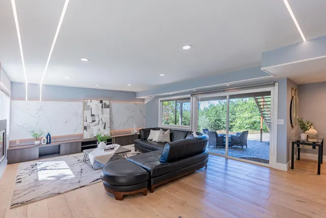an aerial view of a house with a yard swimming pool and lake view