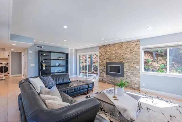 a view of a patio with table and chairs with wooden floor and fence