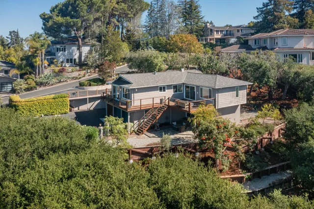 a view of a backyard with table and chairs and potted plants