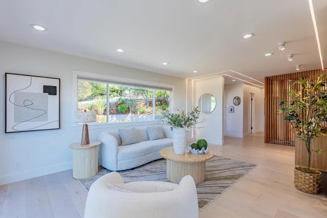 a living room with furniture and a large window
