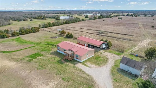 an aerial view of a house with a yard