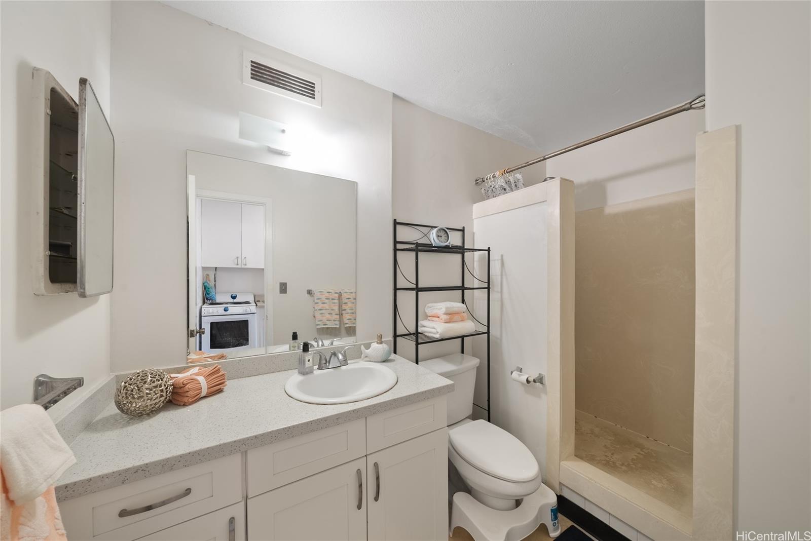 425 Ena Road, Unit B602 Honolulu, HI 96815 - Photo 4 of 16 a bathroom with a granite countertop sink toilet and shower