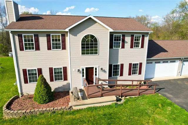 a view of a house with backyard and sitting area