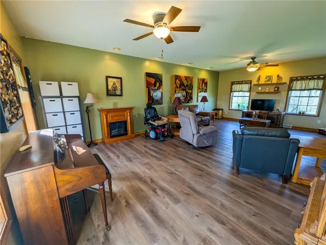 a view of a livingroom with wooden floor and stairs