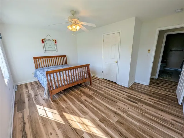 a spacious bathroom with a granite countertop sink a mirror and a bathtub