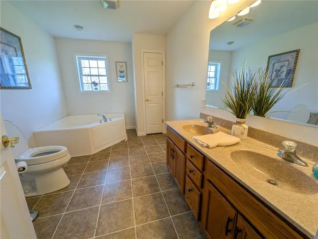 a bedroom with a bed dresser and a window