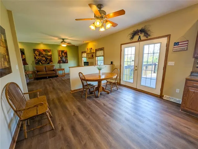 a dining room with furniture and wooden floor