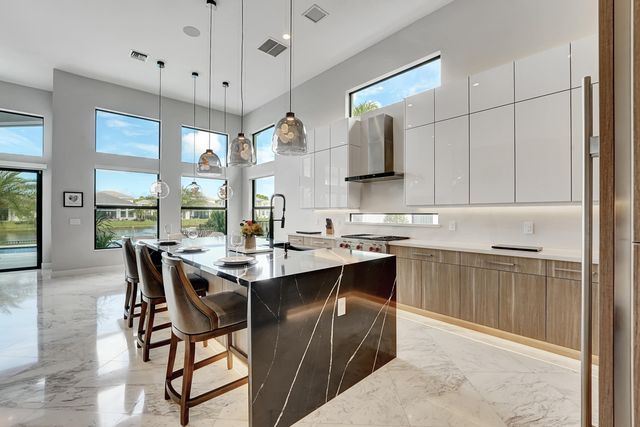 a kitchen with stainless steel appliances granite countertop a sink a stove and a refrigerator