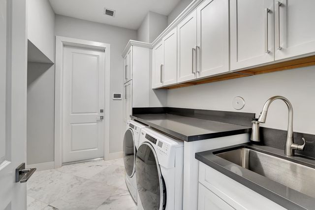 a close view of a sink and cabinets in a kitchen