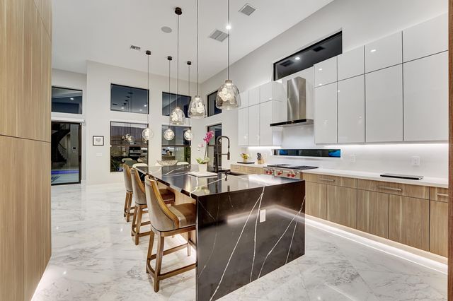 a kitchen with stainless steel appliances kitchen island granite countertop a sink and cabinets