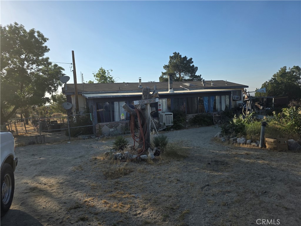 10623 Desert View Road Pinon Hills, CA 92372 - Photo 55 of 76 a view of a house with a yard and hanging chair