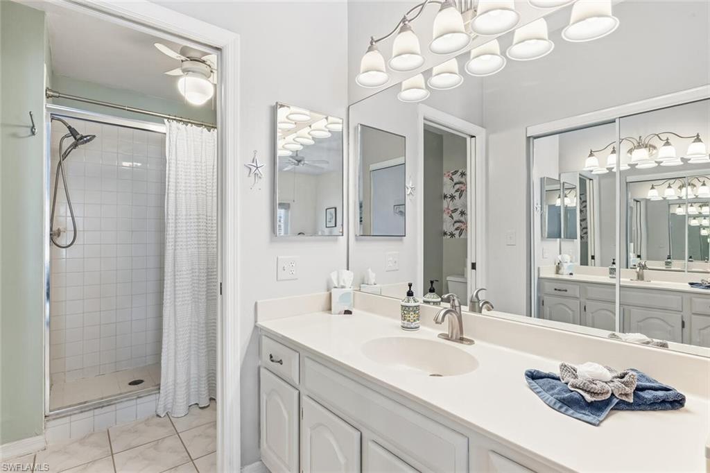 Undisclosed Address Naples, FL 34113 - Photo 15 of 24 a bathroom with a sink vanity granite shower and a mirror