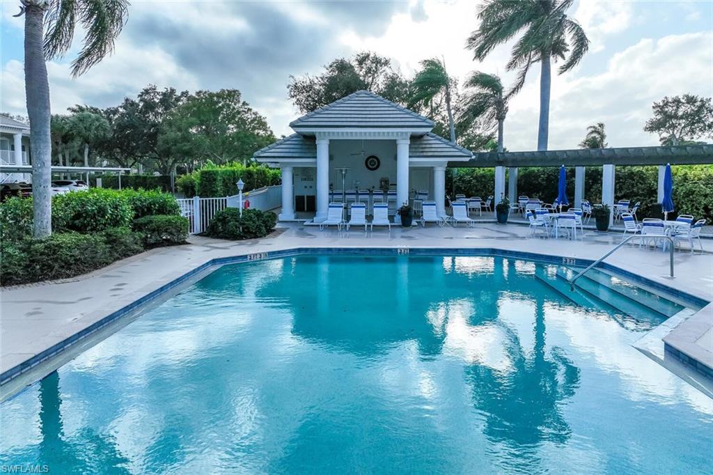 Undisclosed Address Naples, FL 34113 - Photo 21 of 24 a front view of a house with swimming pool garden view and a garden