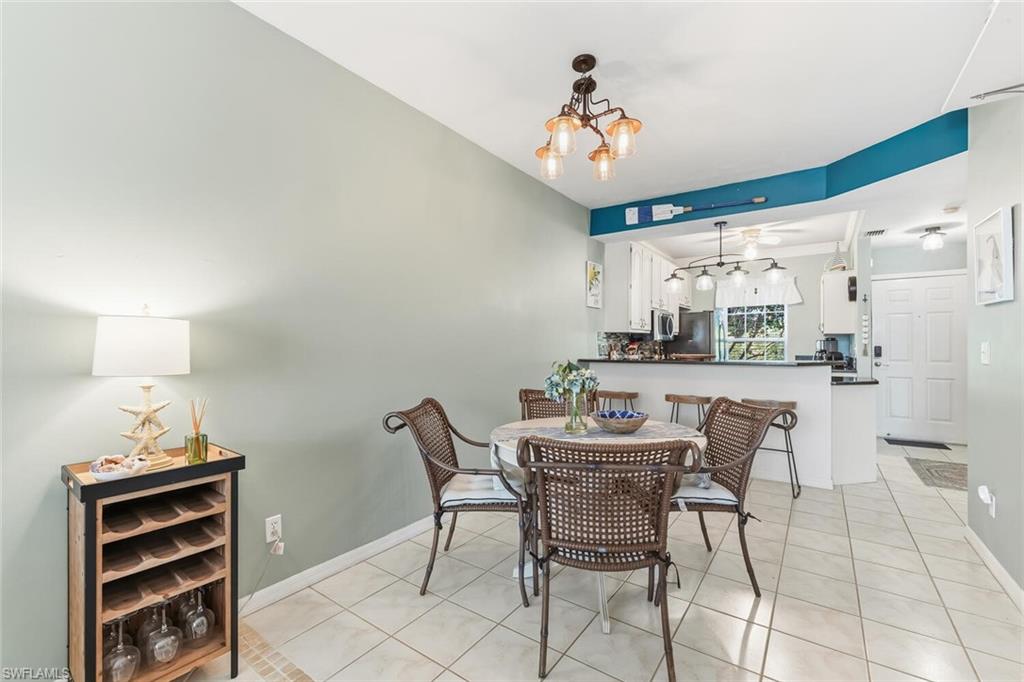 Undisclosed Address Naples, FL 34113 - Photo 7 of 24 a view of a dining room with furniture and chandelier