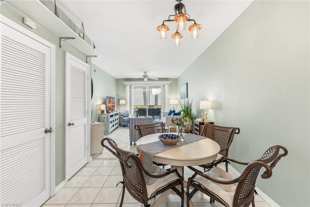 Undisclosed Address Naples, FL 34113 - Photo 8 of 24 a view of a dining room with furniture and a chandelier